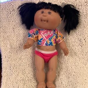 Cabbage Patch doll, hard body, black pigtails and brown eyes.
